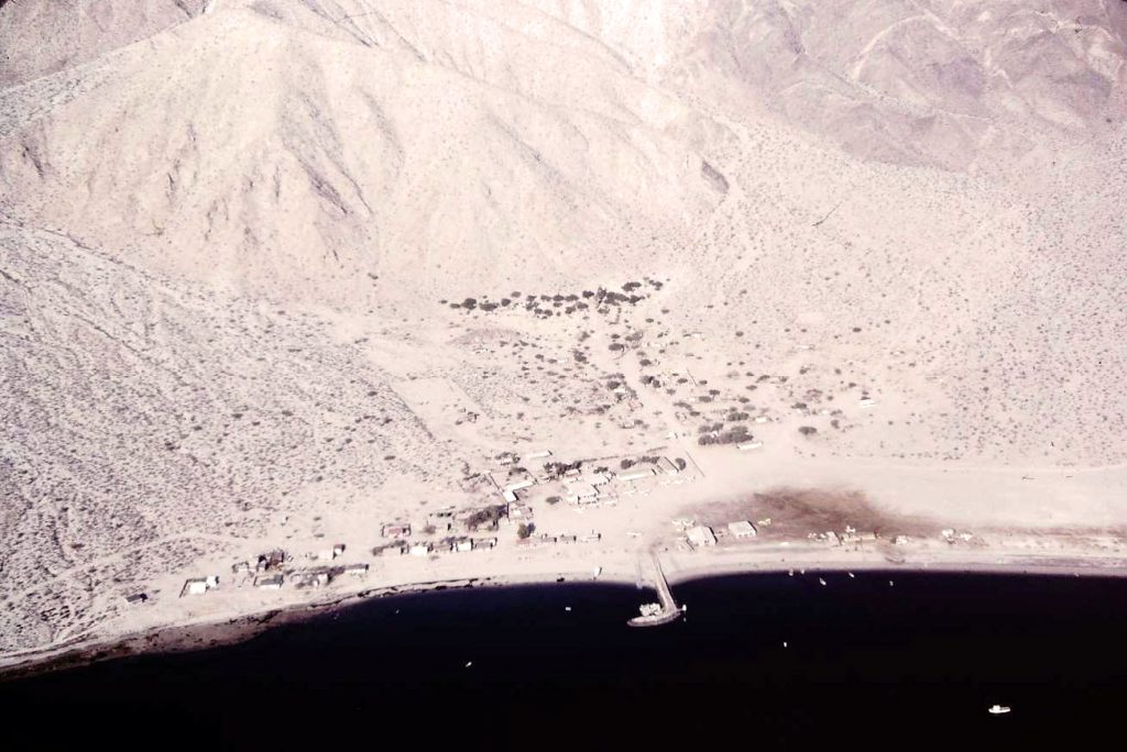 Bahia de los Angeles - Baja California, Mexico in 1972. The runway parallels the beach above the buildings to the right of the pier.